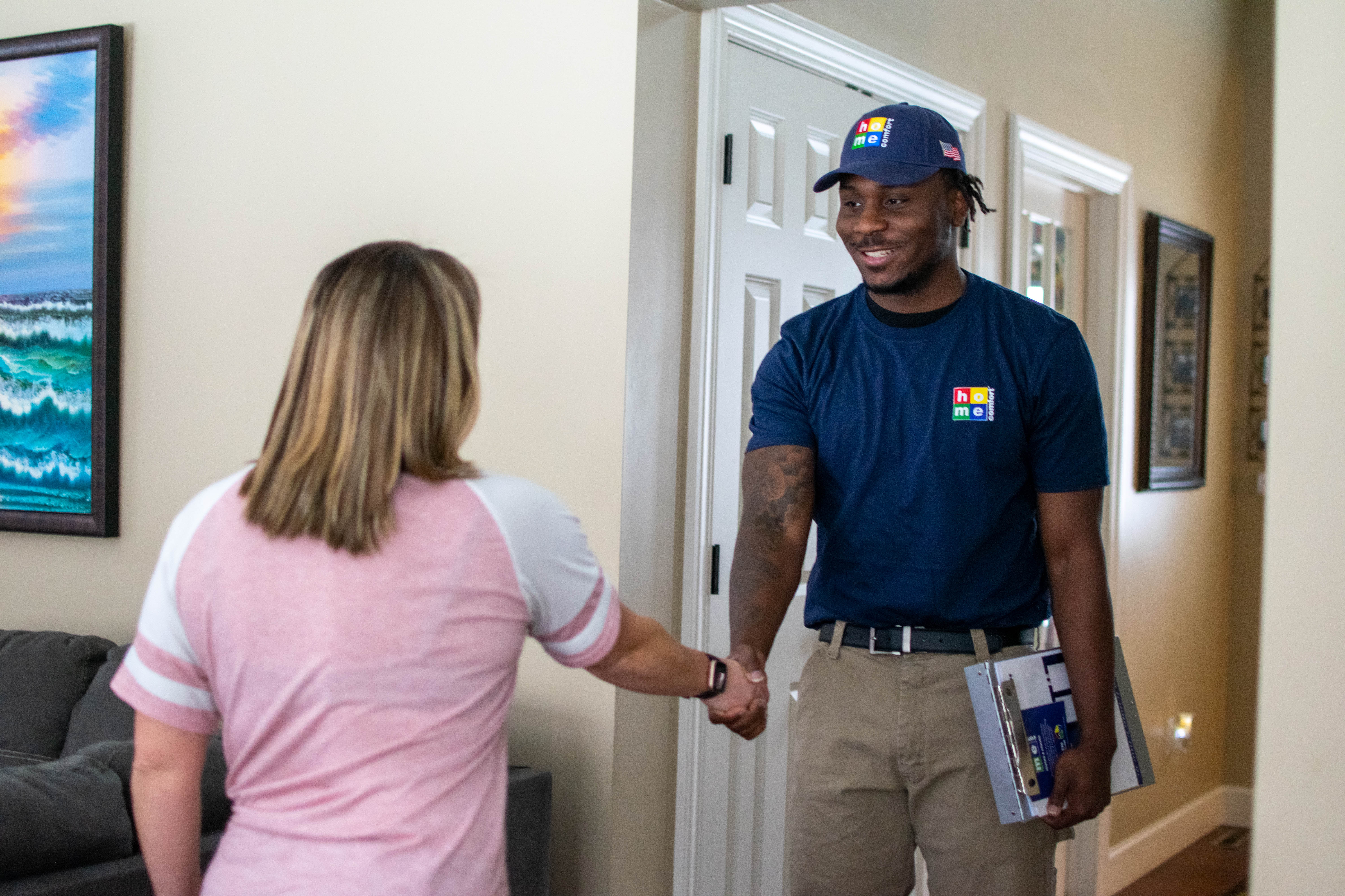 Home Comfort technician greeting an Illinois homeowner by shaking their hand