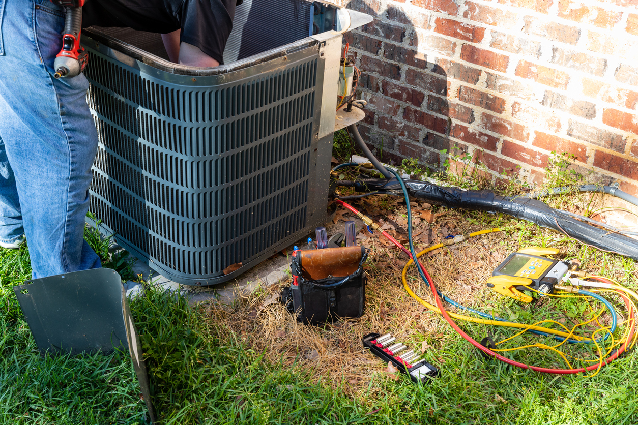 HVAC technician performing a repair service on an AC unit