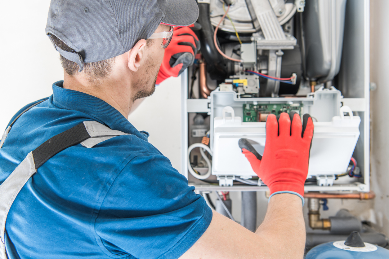 HVAC technician performing furnace repair